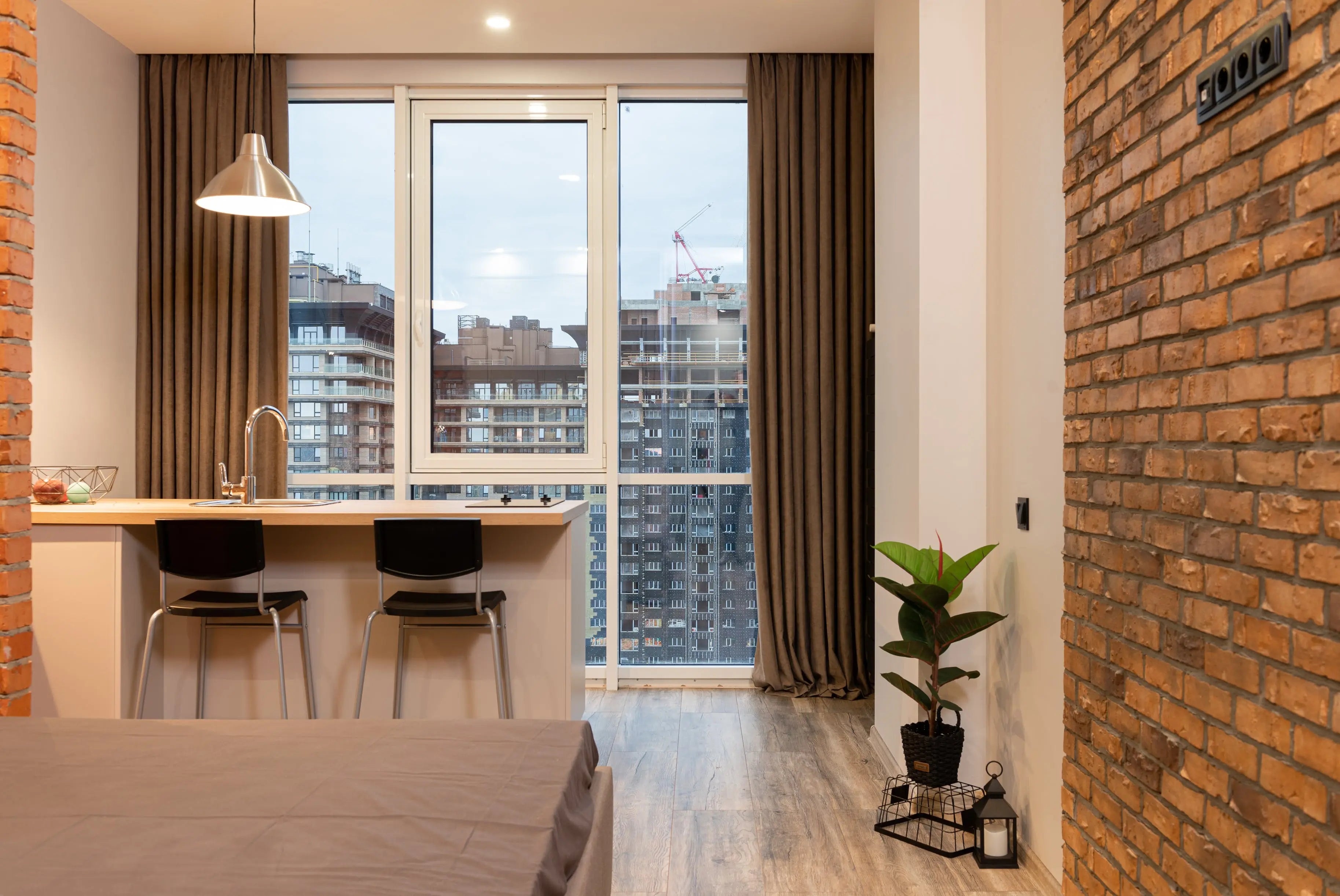 velvet-curtains-hanging-in-the-floor-to-ceiling-windows-of-an-apartment